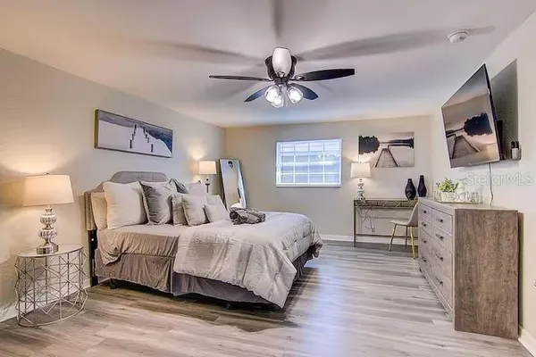 a bedroom with a bed and a flat screen tv