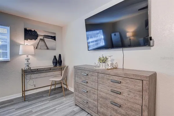 a view of hallway with a large mirror and a dresser