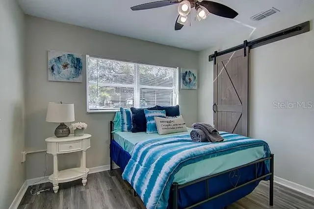 a bedroom with a bed and a window