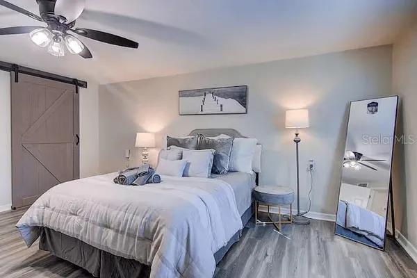 a bedroom with a bed and a chandelier