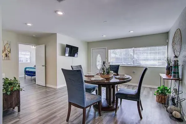 a view of a dining room with furniture and wooden floor