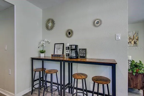 a view of a dining room with furniture and chandelier