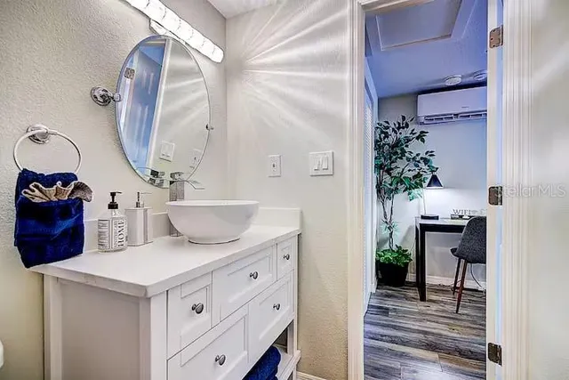 a living room with furniture and a mirror