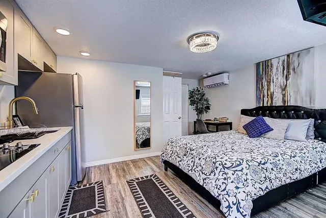 a bedroom with a large bed and a dresser