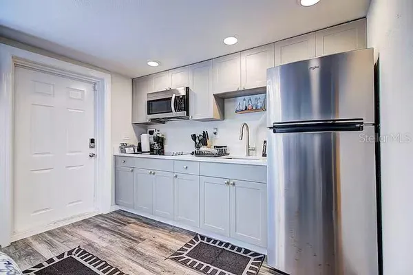 a kitchen with stainless steel appliances a refrigerator sink and microwave