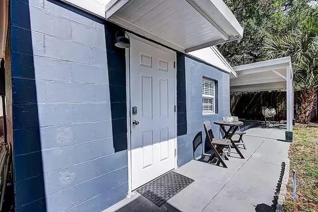 a view of backyard with a table and chairs and a barbeque