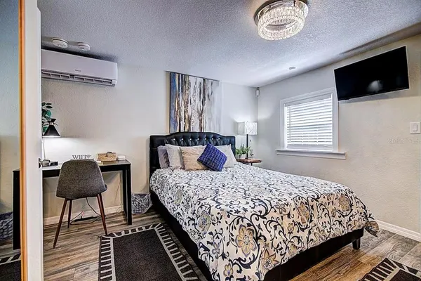 a bedroom with bed and flat screen tv
