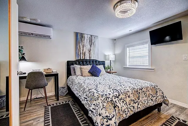 a bedroom with bed and flat screen tv