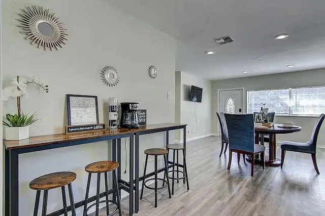 a dining room with furniture and wooden floor
