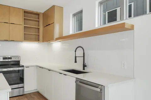 a kitchen with stainless steel appliances granite countertop a sink and a stove