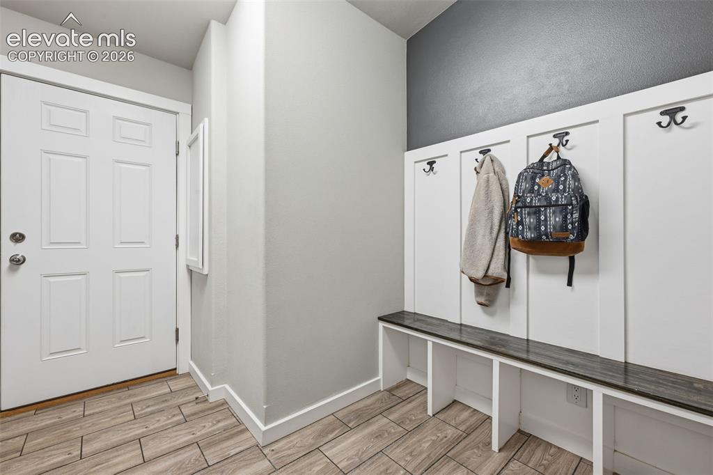 23335 Sanborn Road Calhan, CO 80808 - Photo 24 of 28 Mud room with cubbies, bench seating, and coat hooks designed for country living