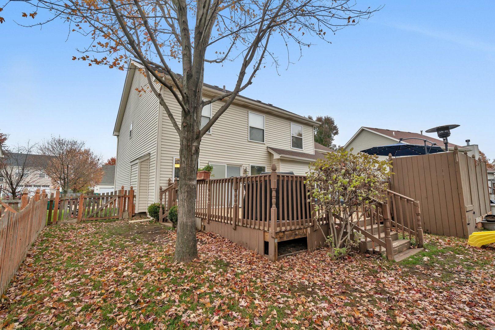 7312 Atkinson Circle Plainfield, IL 60586 - Photo 27 of 27 a view of a house with wooden fence and a bench