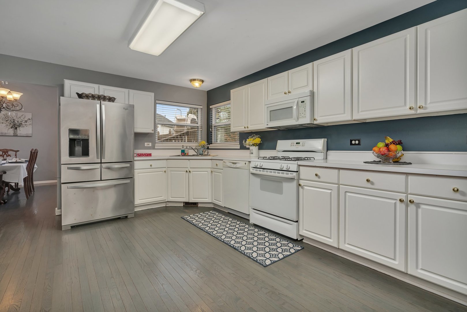 7312 Atkinson Circle Plainfield, IL 60586 - Photo 7 of 27 a kitchen with white cabinets and white appliances