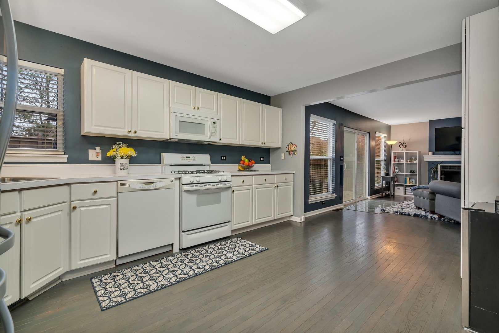7312 Atkinson Circle Plainfield, IL 60586 - Photo 8 of 27 a kitchen with sink cabinets and wooden floor