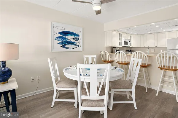 a dining room with furniture a rug and wooden floor