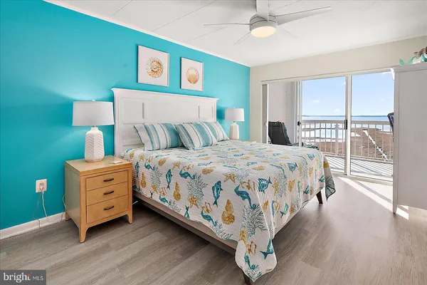 a bedroom with a bed and a view of the dresser