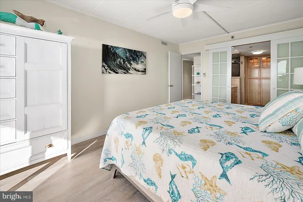 a bedroom with a bed and a painting on the wall