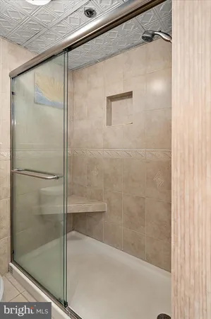 a bathroom with a glass shower door