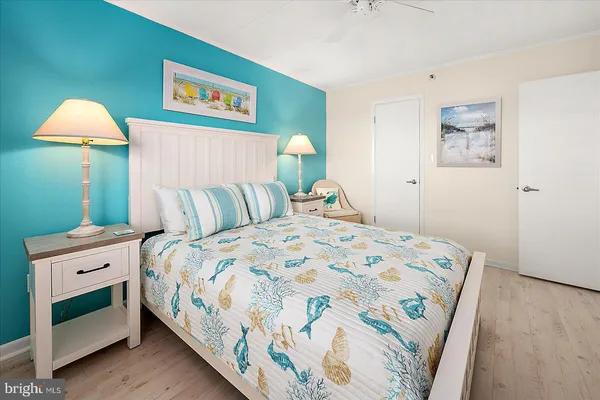 a bedroom with a bed and a lamp