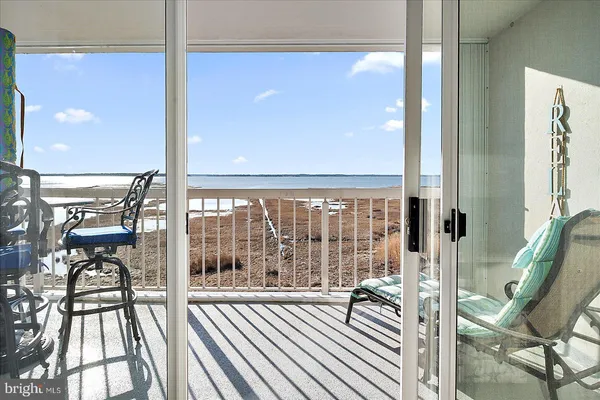 a view of a balcony with wooden floor