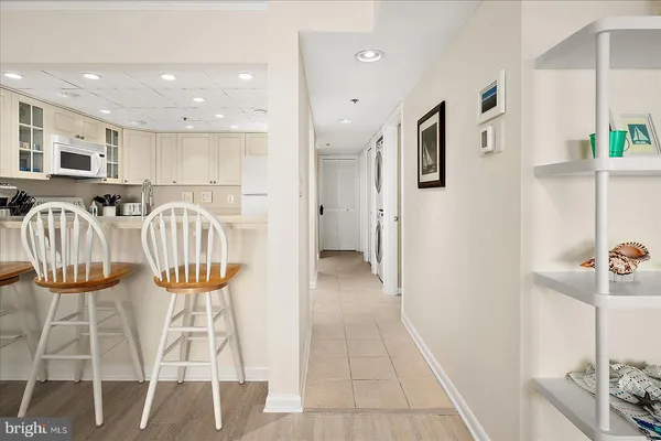 a kitchen with stainless steel appliances kitchen island granite countertop furniture and a wooden floor