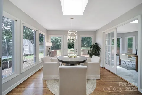 a view of a dining room with furniture wooden floor and chandelier