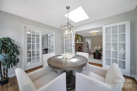 a living room with furniture a chandelier and a window