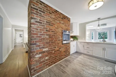 a large white kitchen with cabinets
