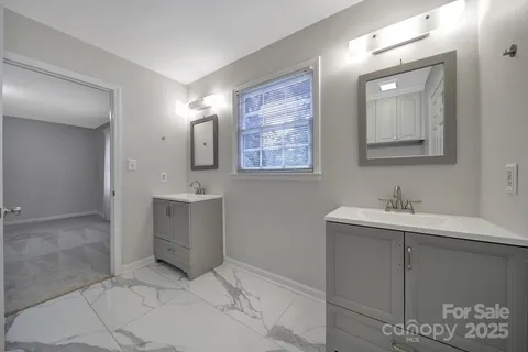 a bathroom with a sink a toilet and mirror