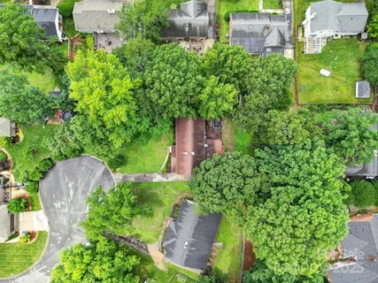 an aerial view of a house with a yard and a fountain
