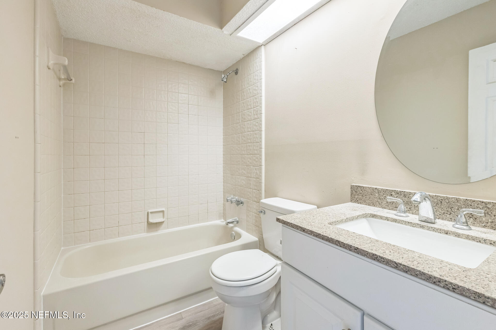 4777 Barnes Road South Jacksonville, FL 32207 - Photo 11 of 15 a bathroom with a granite countertop sink a toilet and a bathtub