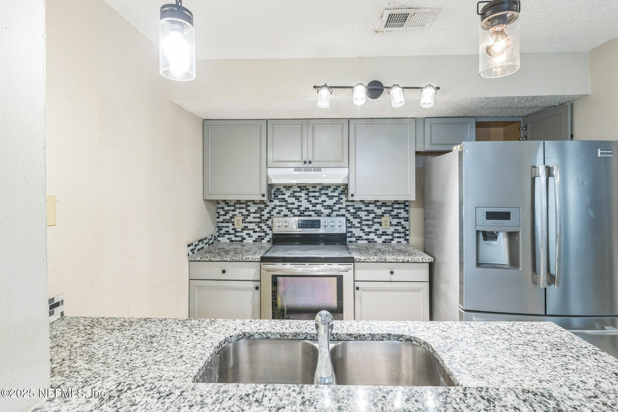 4777 Barnes Road South Jacksonville, FL 32207 - Photo 3 of 15 a kitchen with granite countertop a sink stainless steel appliances and cabinets