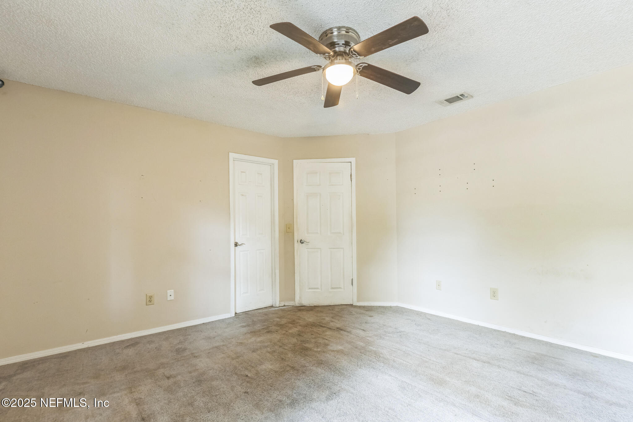 4777 Barnes Road South Jacksonville, FL 32207 - Photo 10 of 15 an empty room with a ceiling fan and a window