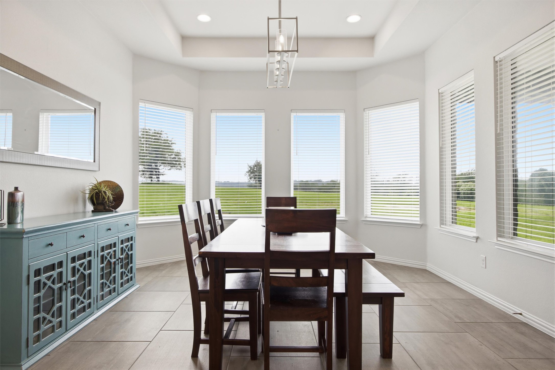 192 Raptor Beak Way Cedar Creek, TX 78612 - Photo 13 of 38 Dining area featuring a tray ceiling, recessed lighting, and multiple windows