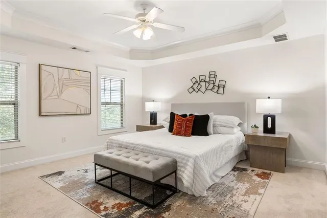 a bedroom with a bed and a table in it with window