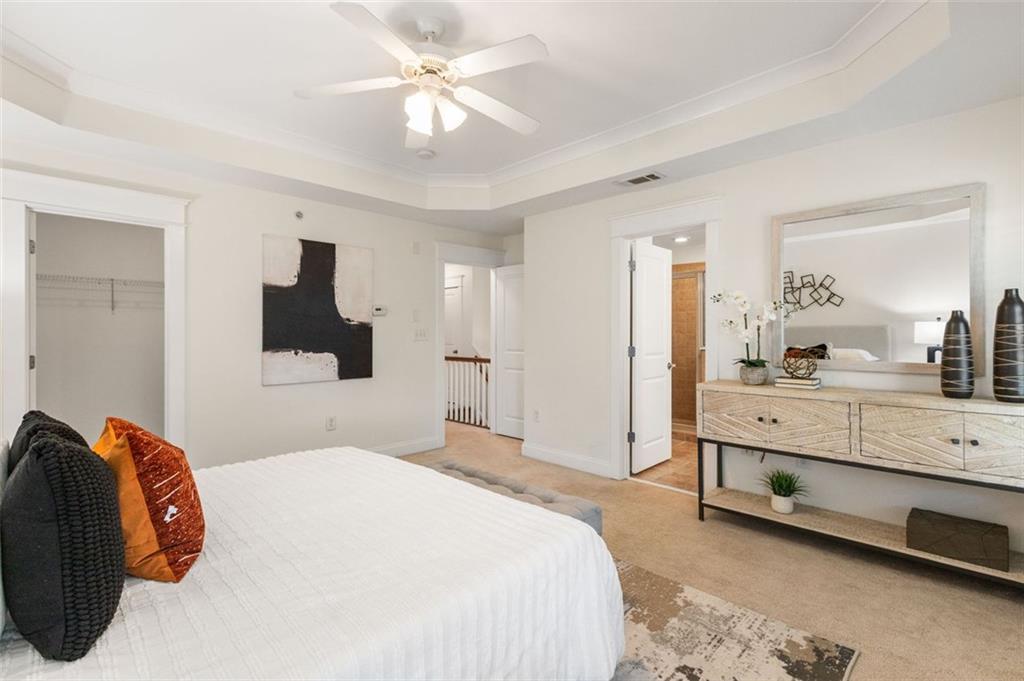 655 Mead Street Southeast, Unit 54 Atlanta, GA 30312 - Photo 15 of 25 a bedroom with a bed and a chandelier