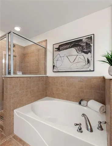 a bathroom with a white bath tub and a shower