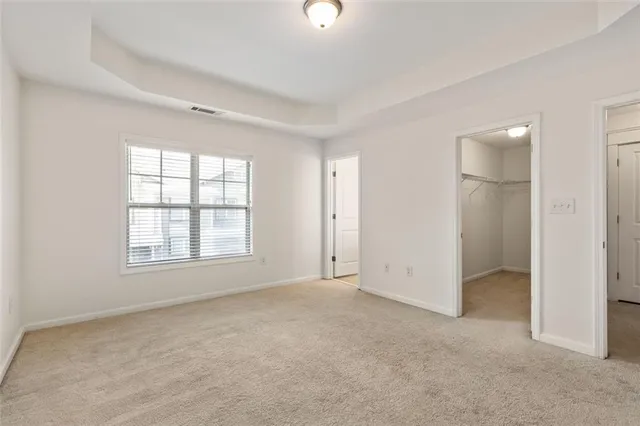 an empty room with windows and entrance