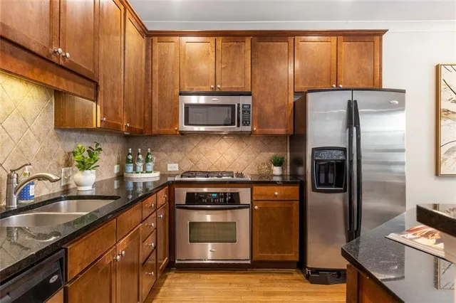 a kitchen with a sink stove and refrigerator