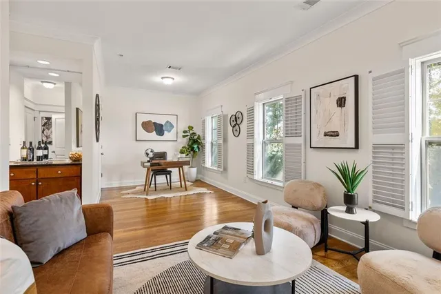 a living room with furniture and wooden floor