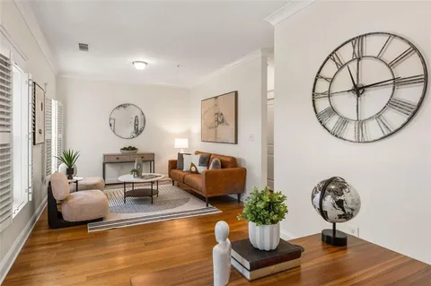 a living room with furniture chandelier and a mirror