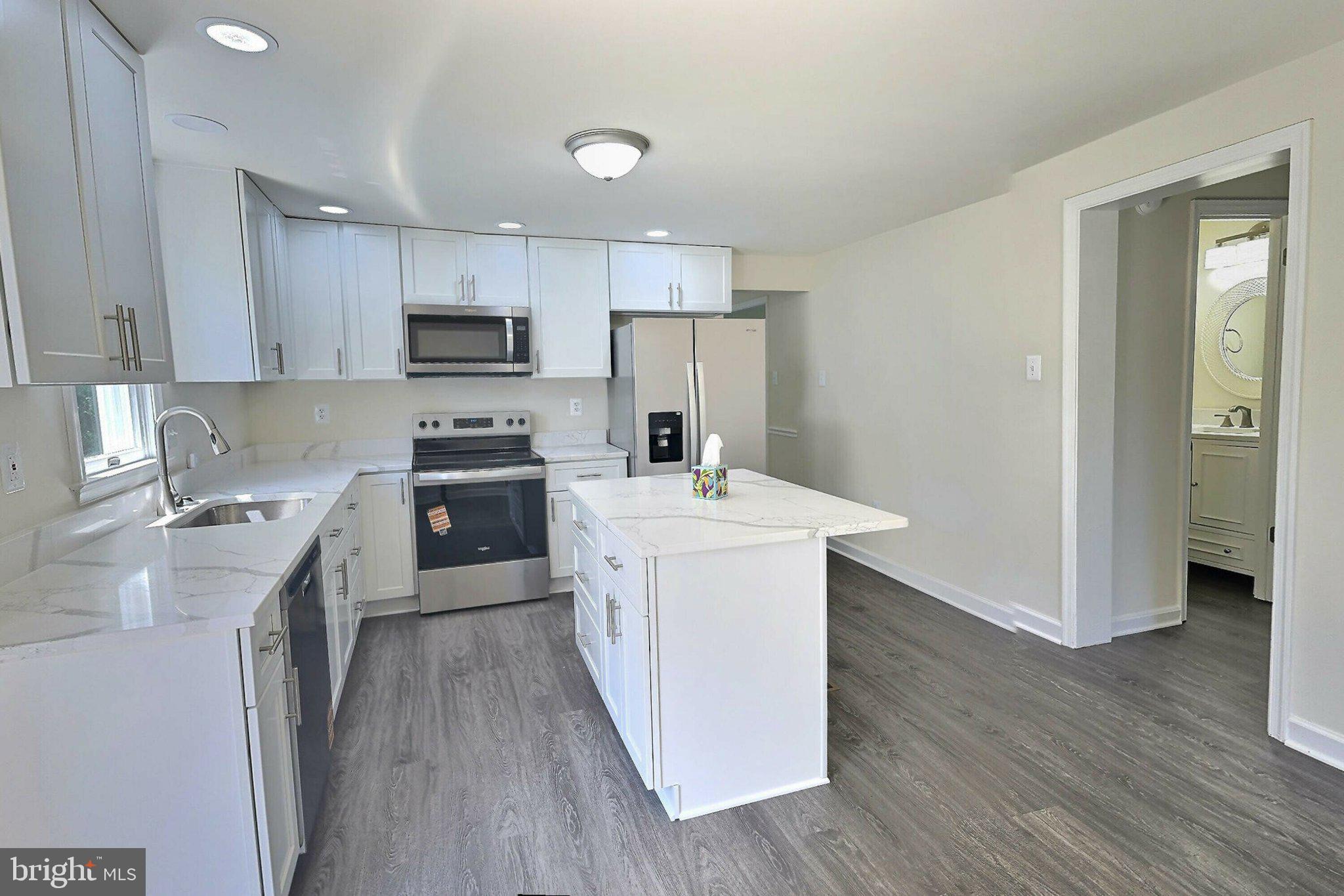 2001 Powder Horn Drive Fort Washington, MD 20744 - Photo 15 of 26 a kitchen with a sink a counter top space stainless steel appliances and cabinets