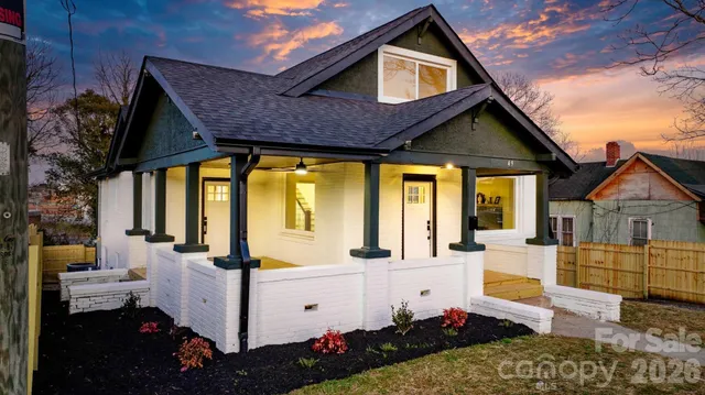 a view of a kitchen with wooden floor and a window