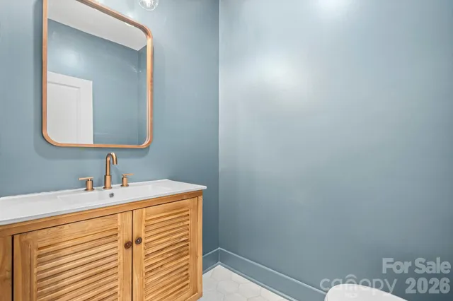 a bathroom with a sink vanity and a mirror