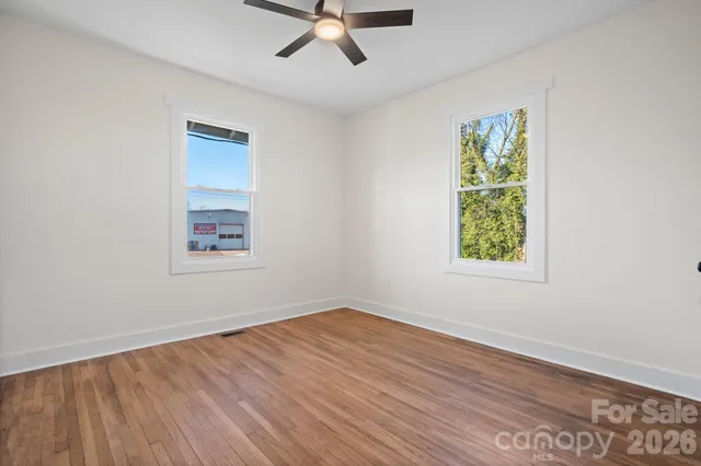 a view of a room with wooden chairs