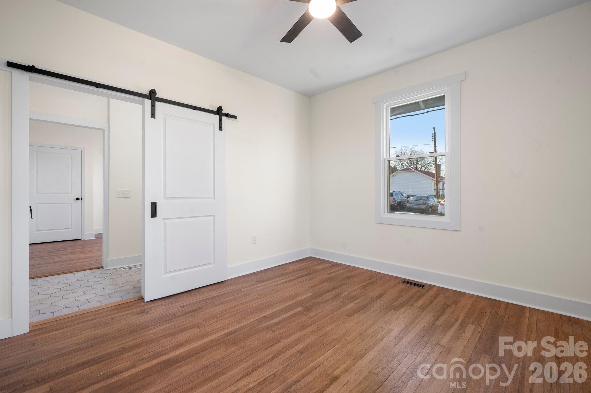 49 8th Street Southeast Hickory, NC 28602 - Photo 23 of 39 wooden floor in an empty room with a window