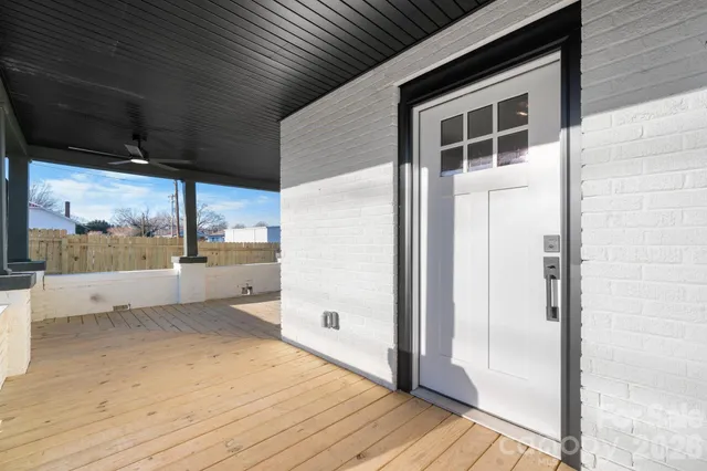 a view of a kitchen with wooden floor and a sink