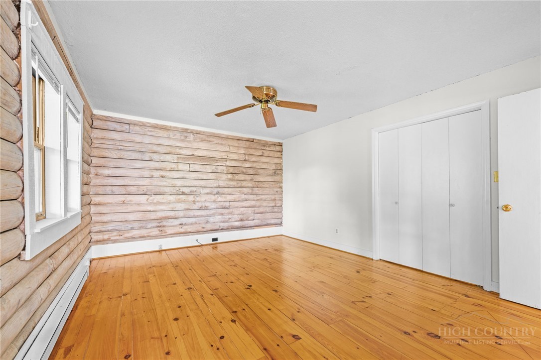 233 Alpine Acres Road Vilas, NC 28692 - Photo 12 of 32 a view of an empty room and wooden floor and a window