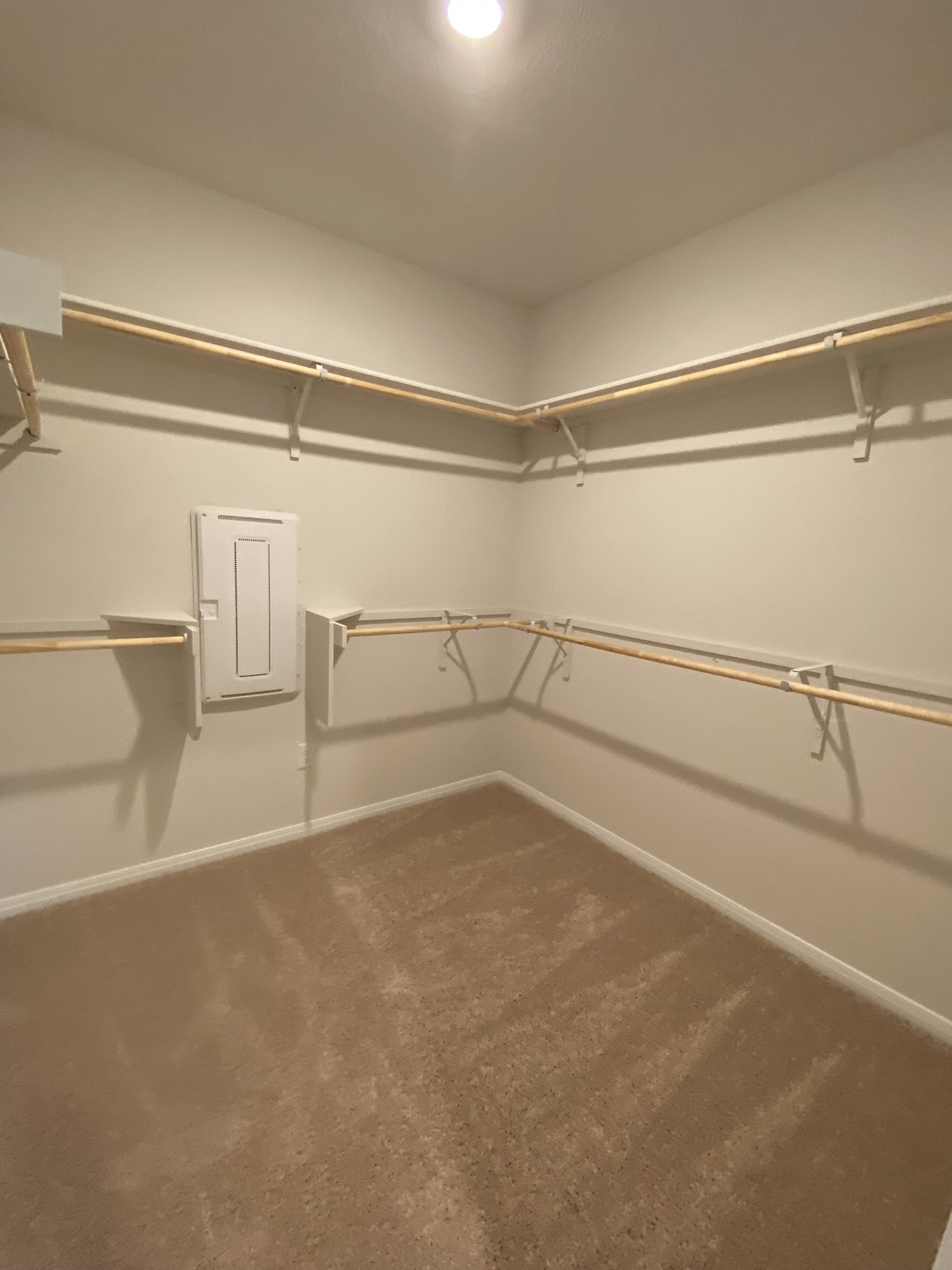 236 Sunniberg Loop Georgetown, TX 78626 - Photo 13 of 22 Multi-tier hanging rods maximize storage capacity in this carpeted walk-in closet.
