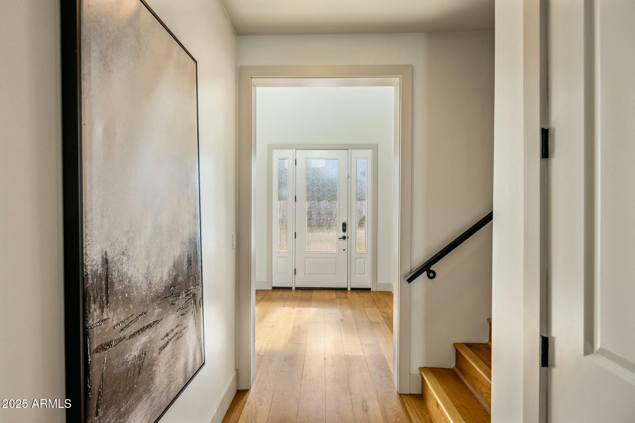 3902 East Fairmount Avenue Phoenix, AZ 85018 - Photo 11 of 32 a view of a hallway with wooden floor and staircase